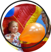 A small girl playing with a balloon.